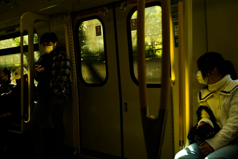 people sit inside and look out of the bus doors