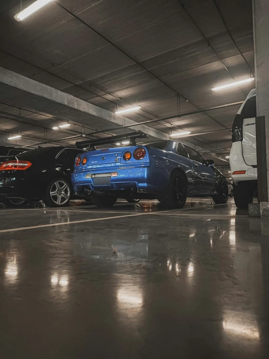 two trucks are parked next to each other in a parking garage