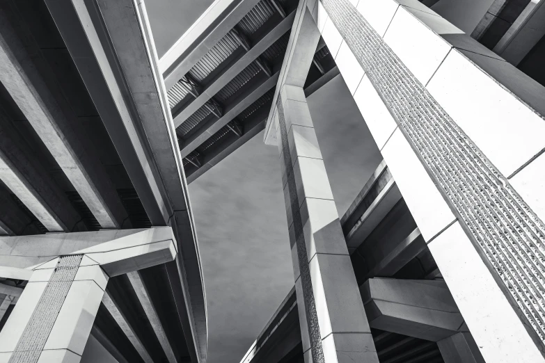 two buildings are pictured from below, one black and white