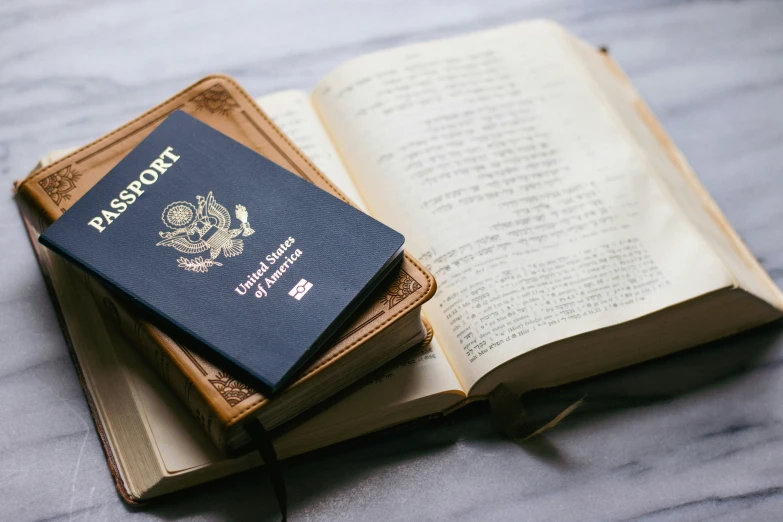 a passport is placed on top of an opened book