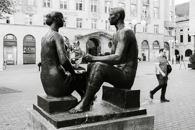 a statue sitting on top of a stone pedestal