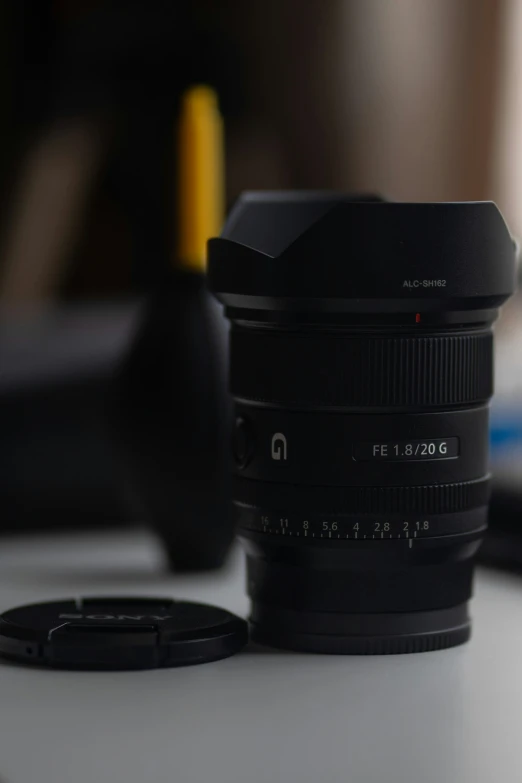 a lens sitting on a table next to some wires