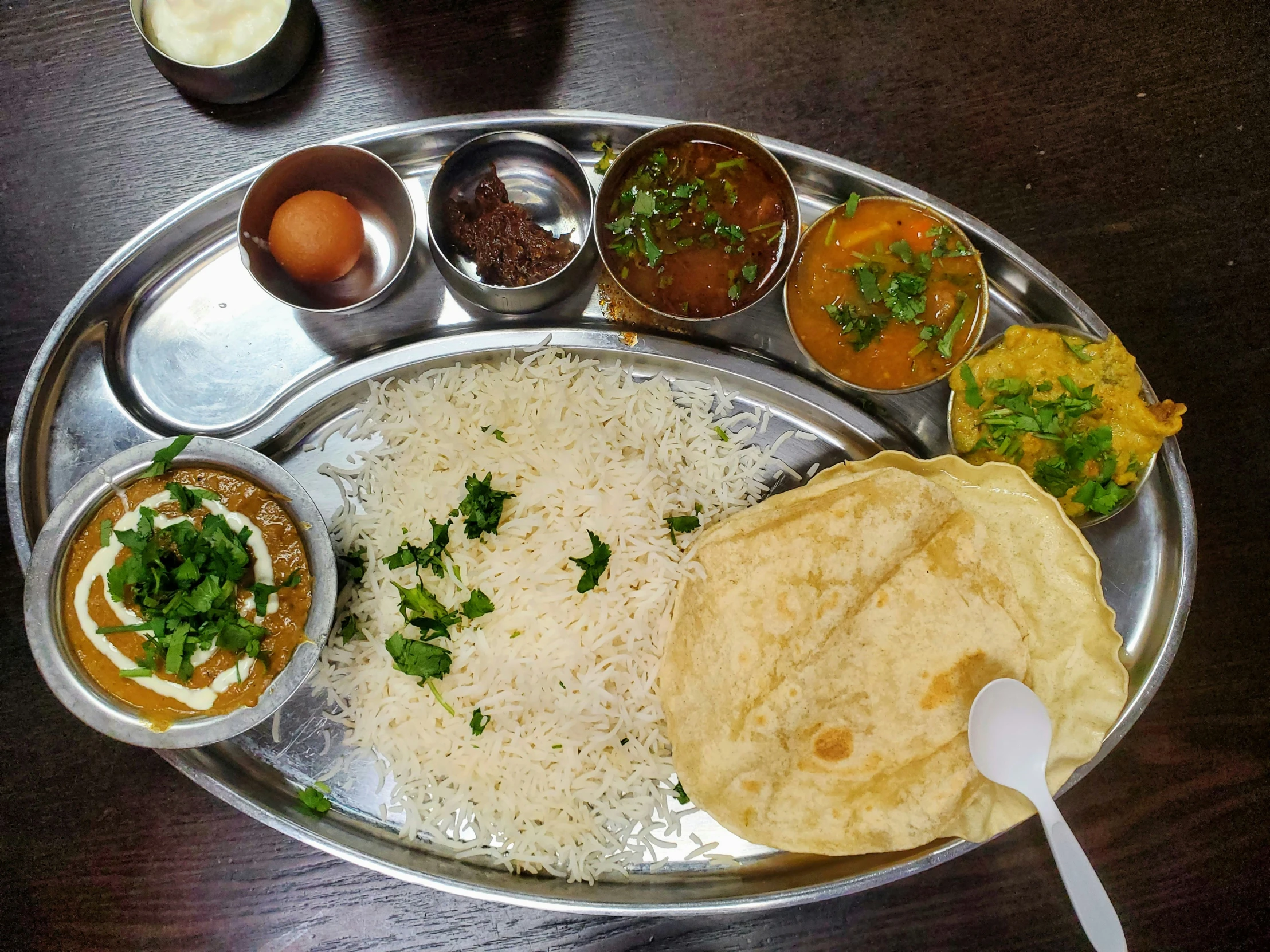 this metal plate has a lot of food on it