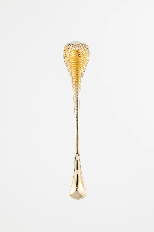 the golden snake head spoon has an ornate design