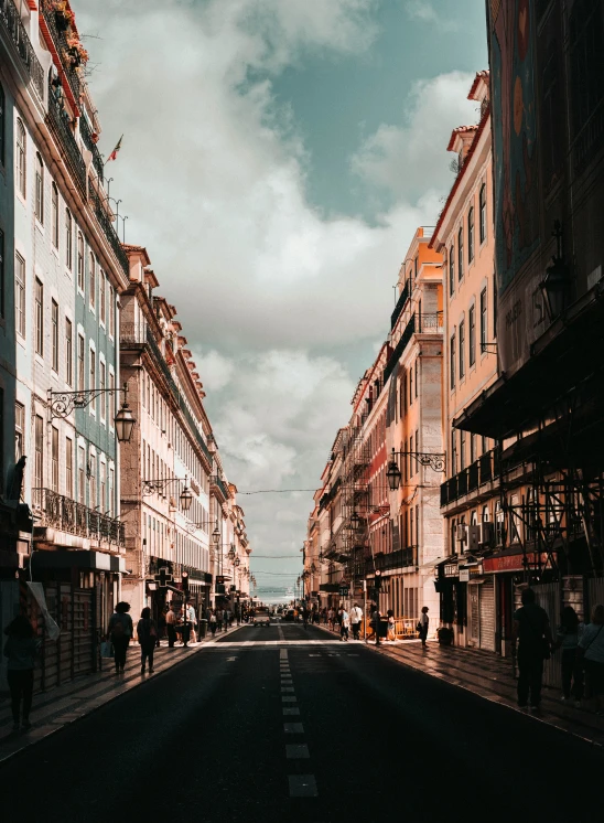 an empty city street has shops on the sidewalk