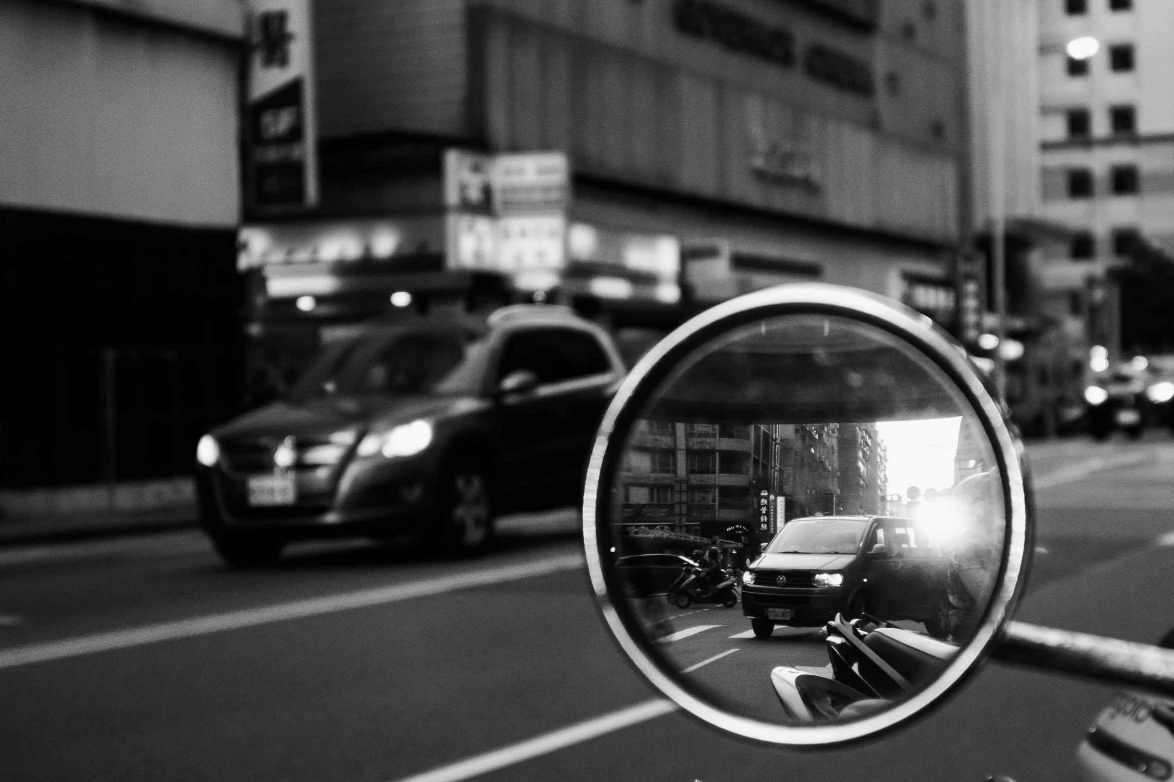 a rear view mirror is shown in a street