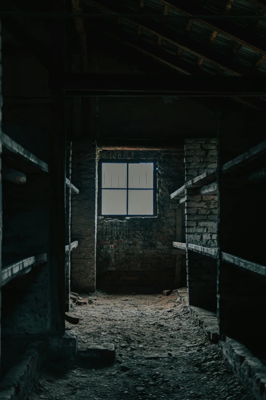 a black room with a window, brick walls and metal railings