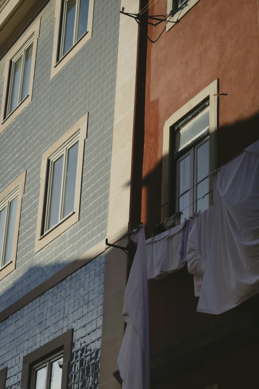 clothes hanging out to dry on a line by a building