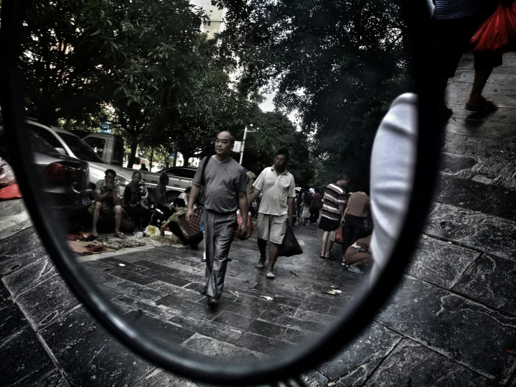 a close up of a person's eye looking at their reflection in a rear view mirror