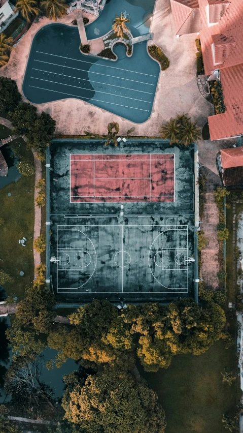 an overhead view of an outdoor court with a tennis court