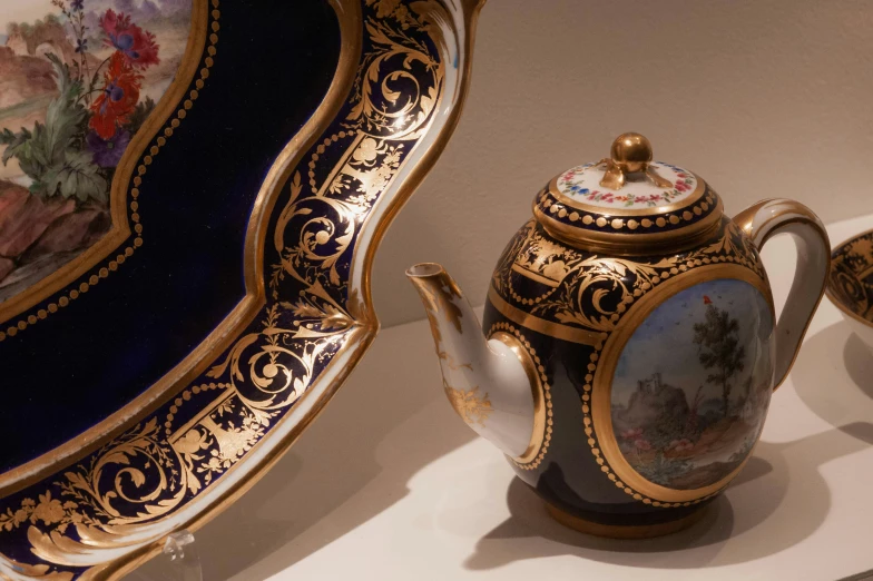 an ornately decorated tea set with gilded decorations