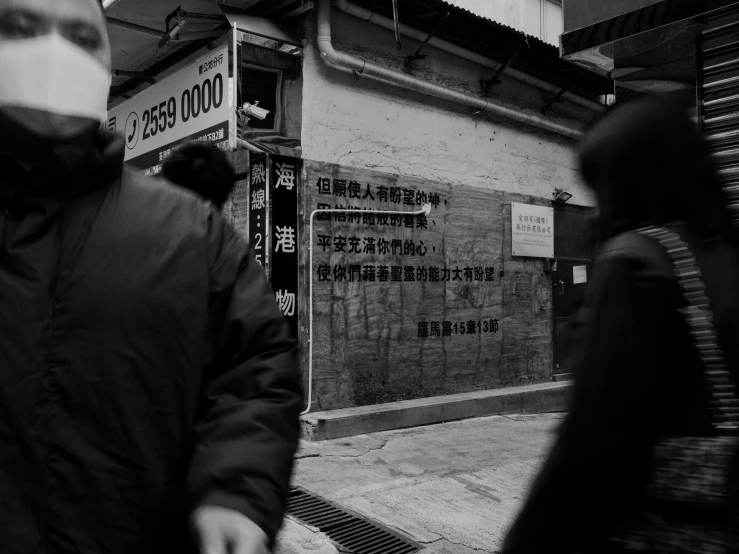 a man walking in a street near a tall building