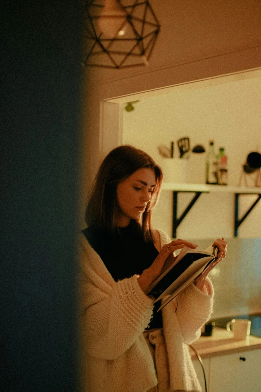 the girl reads her recipe while she sits down