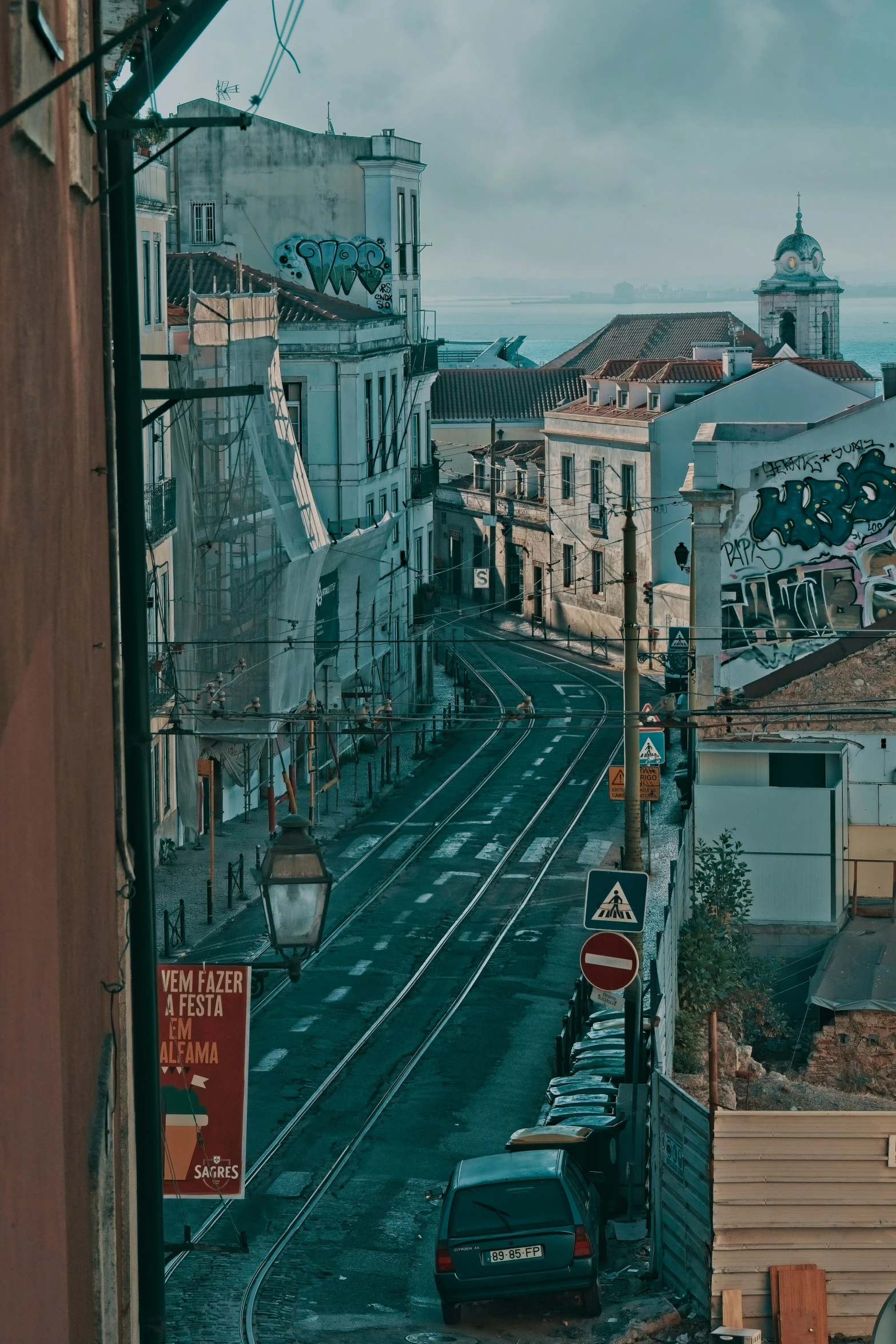 a street with a few buildings and lots of traffic