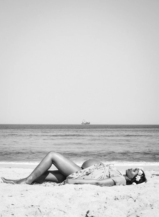 a person that is lying down on the beach
