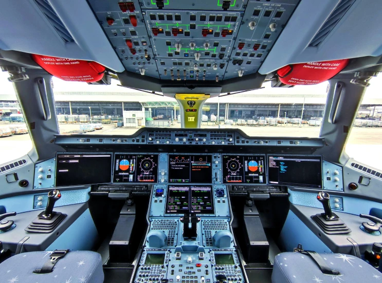 the inside view of an airplane cockpit with the control panel and pilot's seats