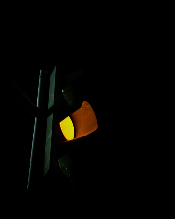 a traffic light at night is shown yellow