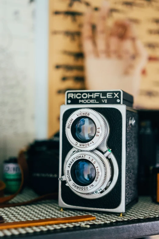 a camera sits on a table in front of other objects