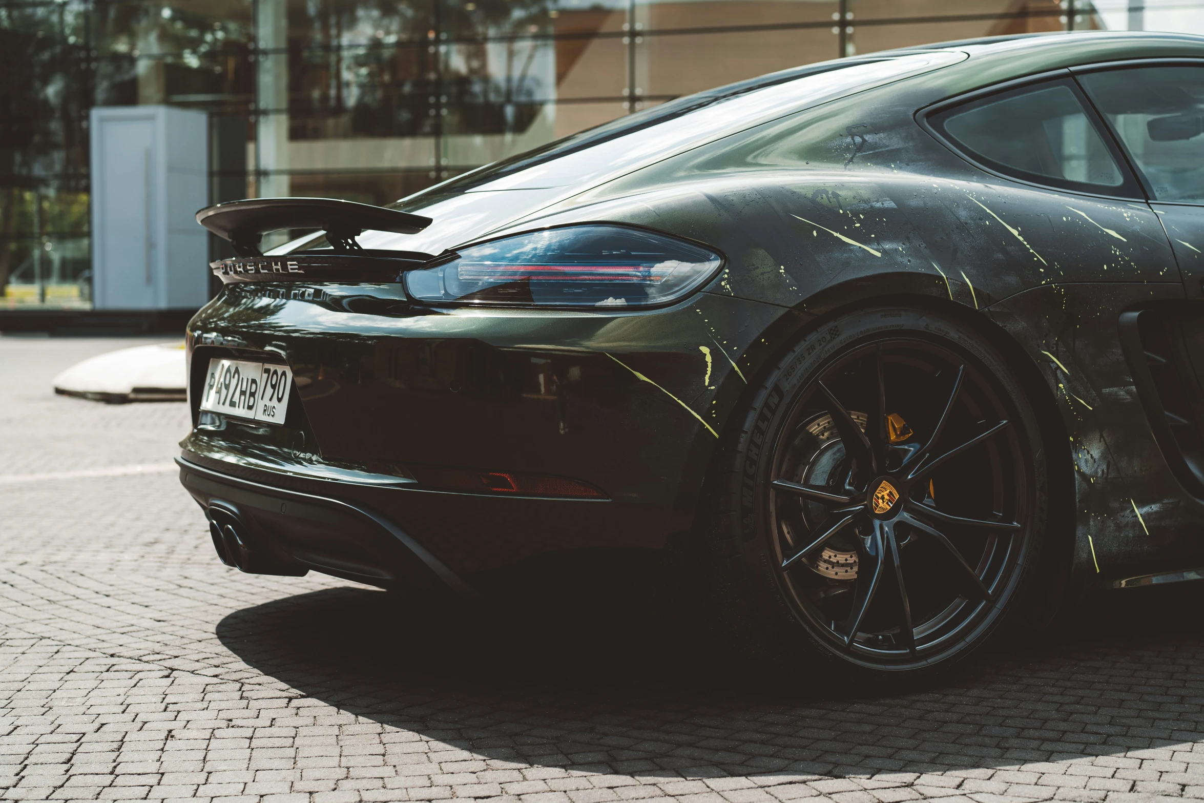 the front wheels of a black car with rust