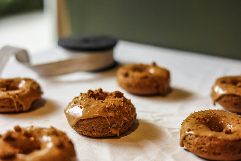 doughnuts have been topped with icing sitting on a counter