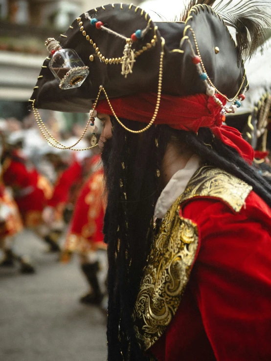 the costumed man is wearing a mask of feathers