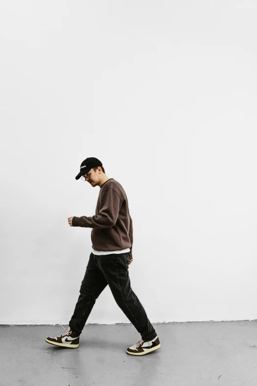 a person wearing hat, pants, and shoes walking