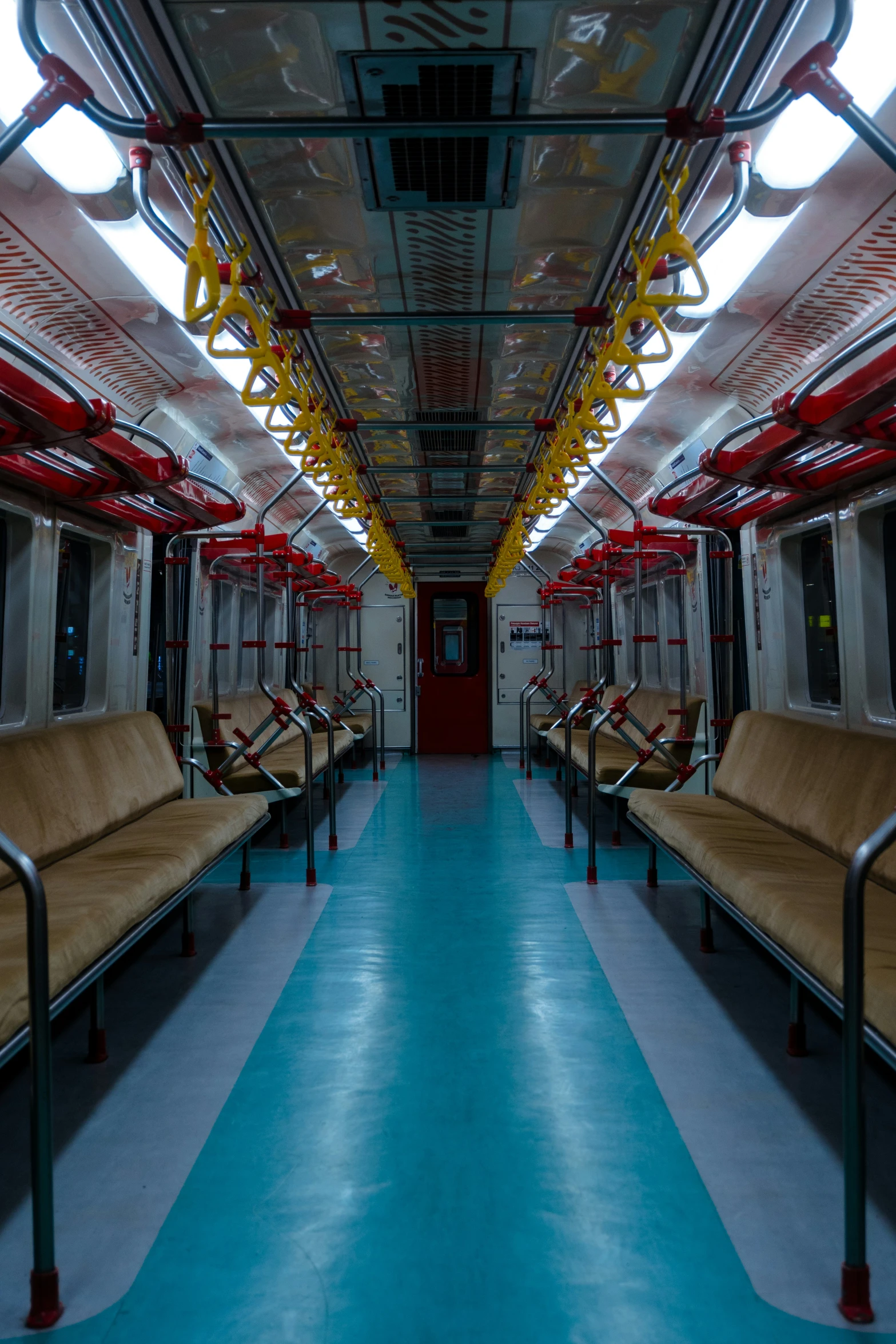 several couches inside a train car with blue flooring