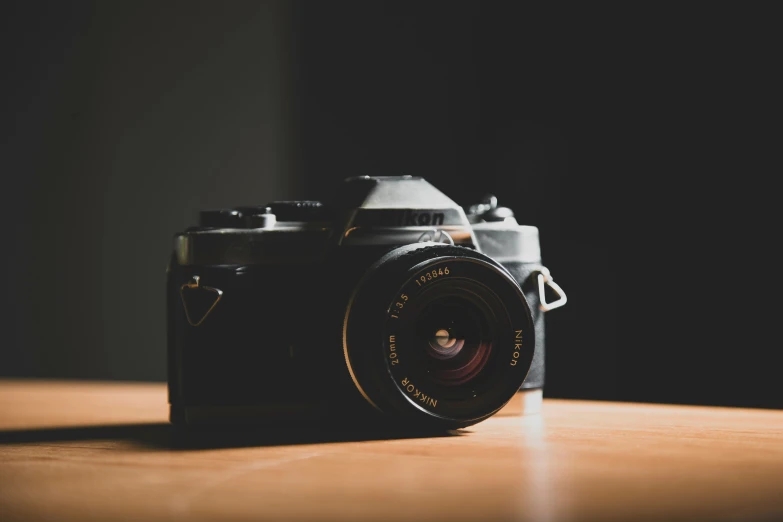 a camera sitting on top of a table next to the camera lens