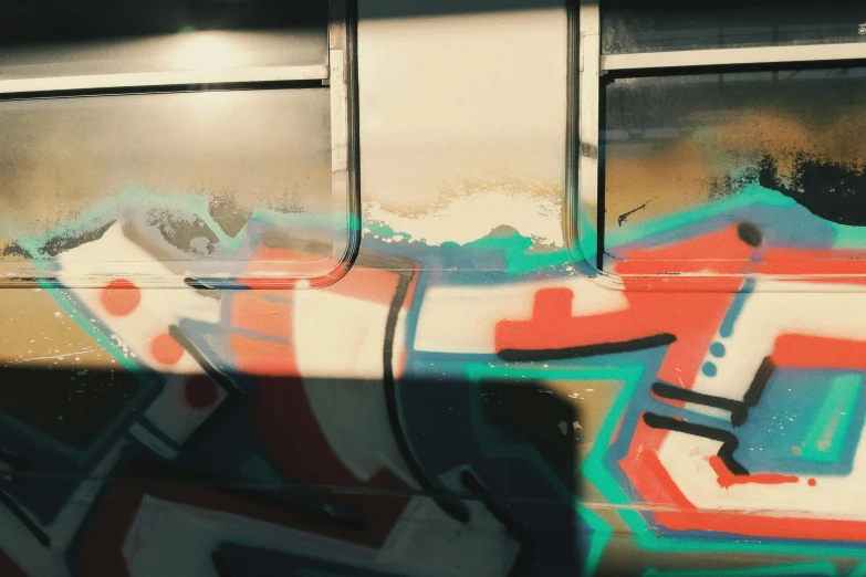 the side of a bus with grafitti on it