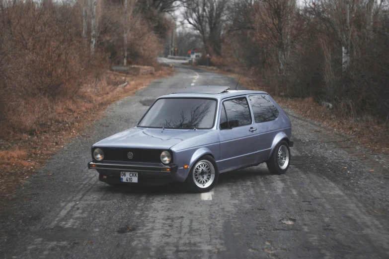 a small car is sitting on the side of a road