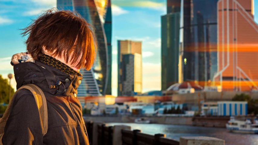 a person with long hair walking down a pier