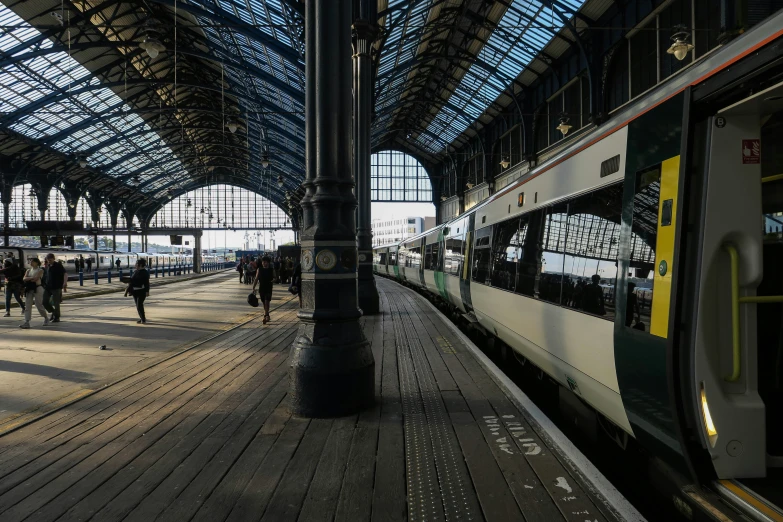 the train station is surrounded by metal pillars and glass