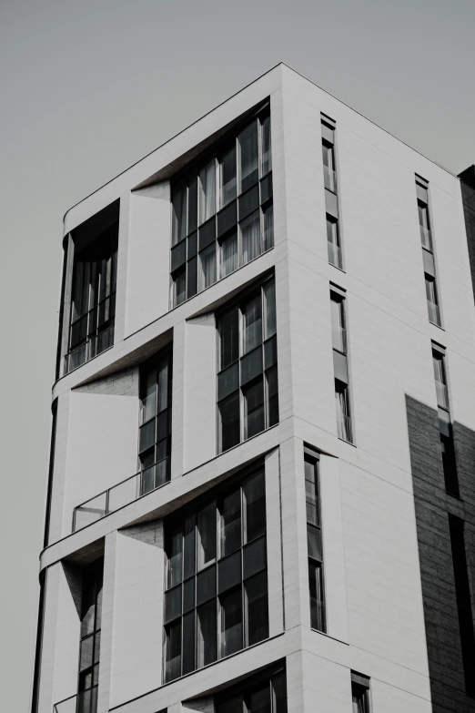 a tall building with windows on one side and no curtains