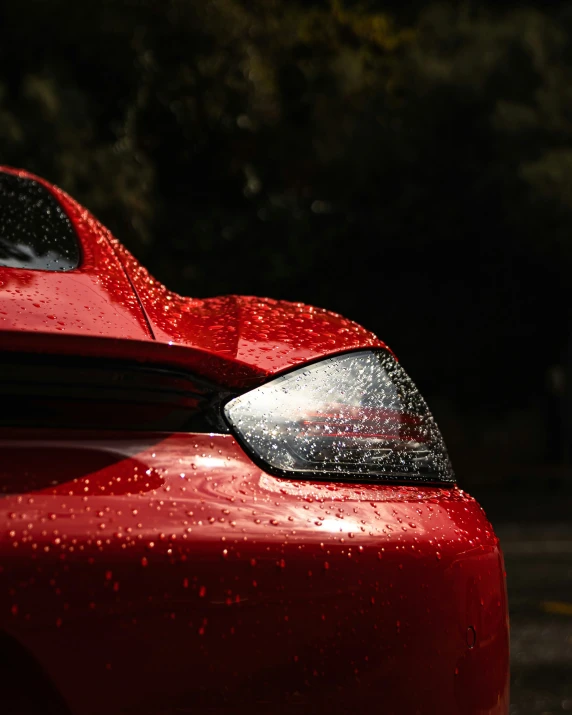 the reflection of a car, hood up, on wet asphalt