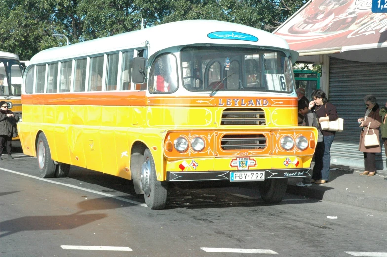 some yellow busses and people on the street