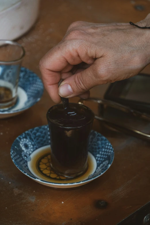 a person is reaching for soing in a glass