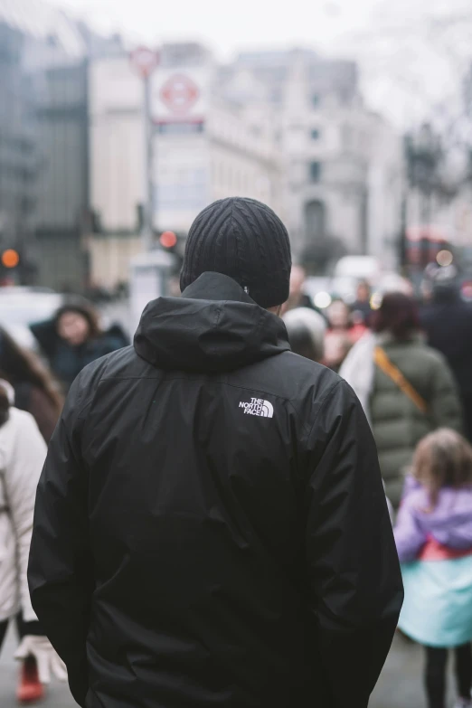 a man walks through a crowd of people on the street