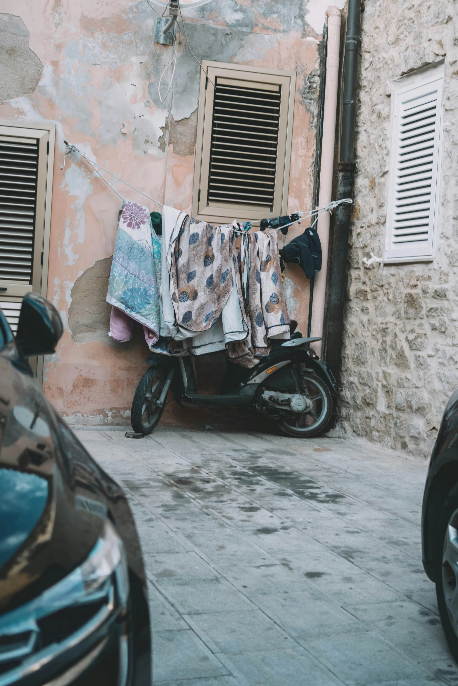 two parked motorcycles in front of a pink building