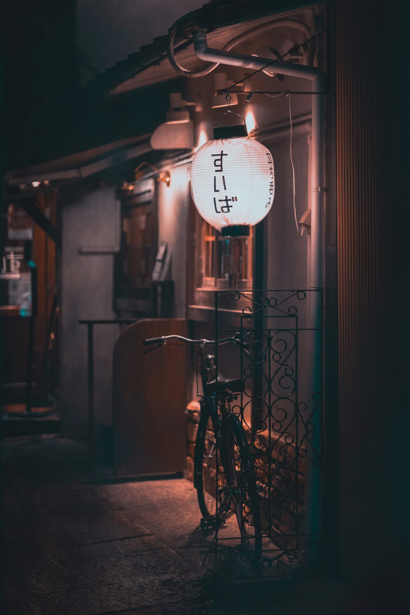 an empty bike parked in a darkened street