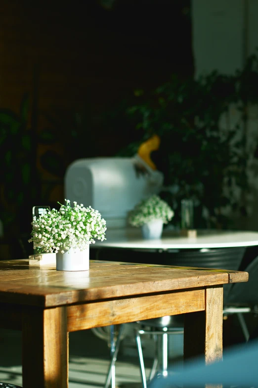 a wooden table with white and grey vases on it