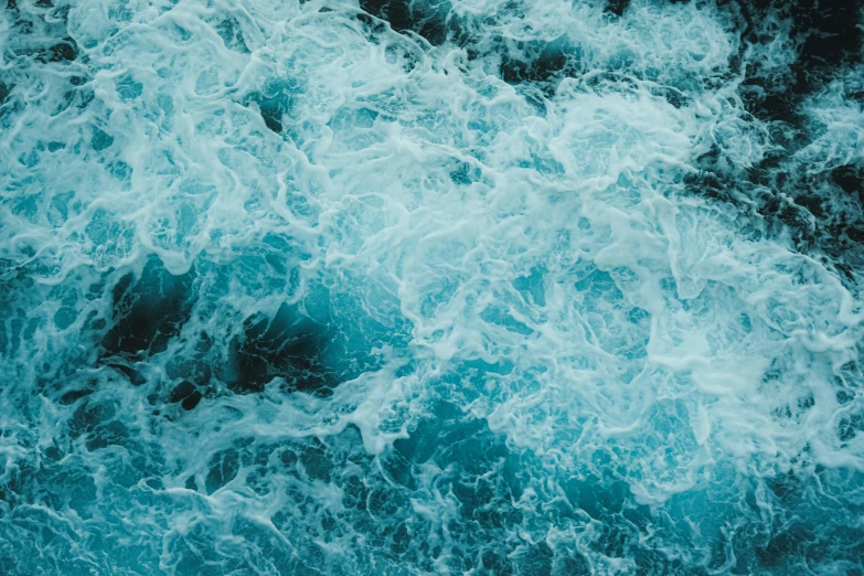 water swirls around a boat that is in the ocean