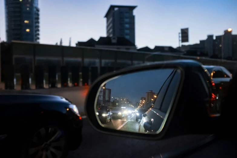 a rear view mirror in front of some cars