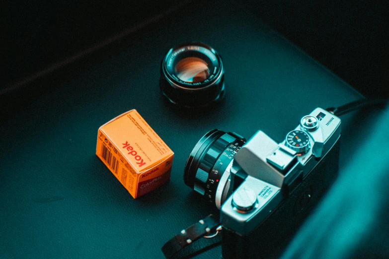 a close up of a camera and box on a table