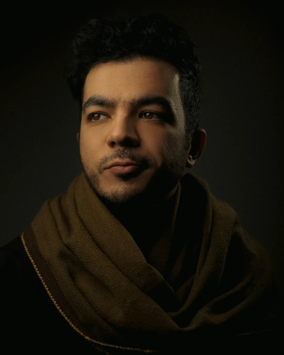 a man with a brown scarf over his neck