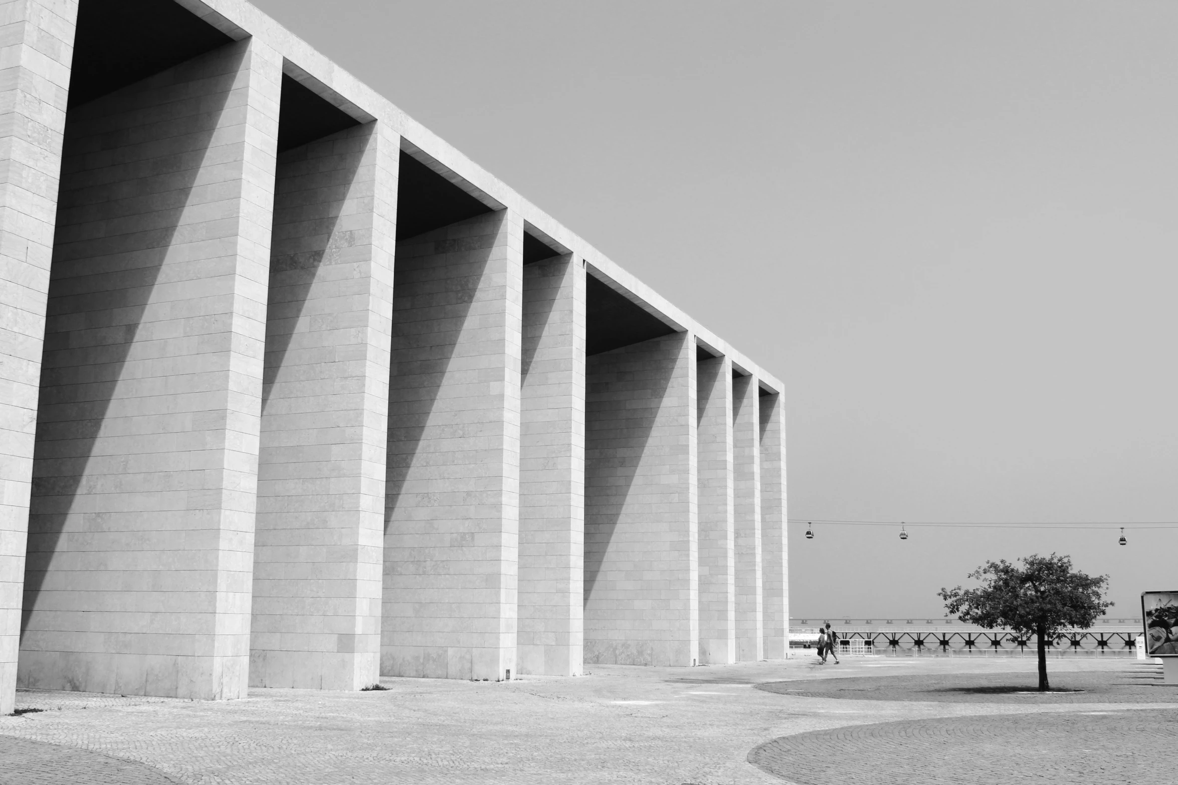 the concrete columned wall has four different columns at one side