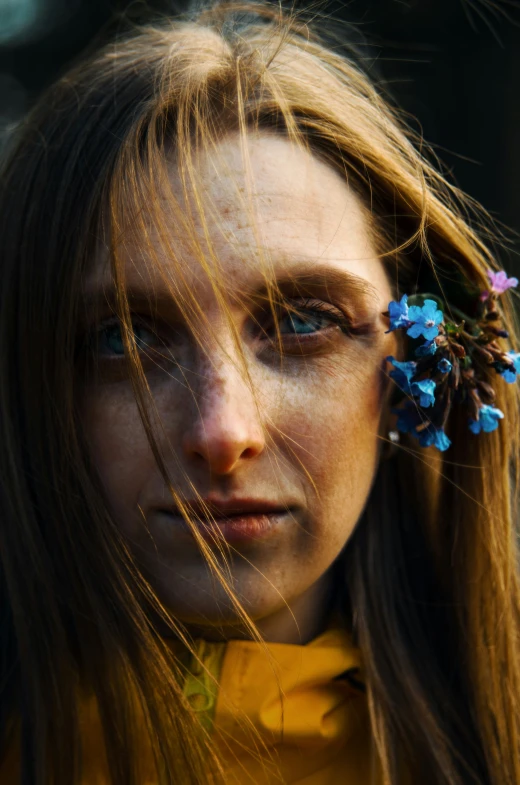 a close up of a young woman with flowers in her hair