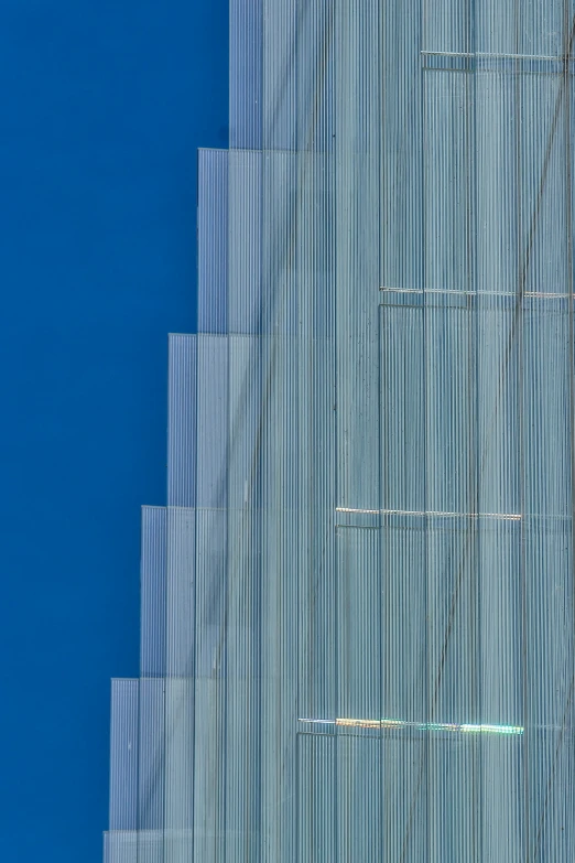 blue wall with lines against it, with sky in the background