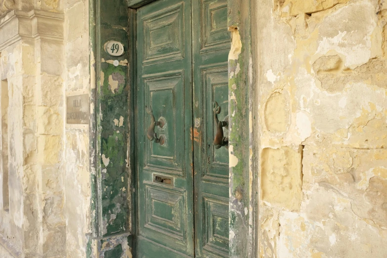 an old door with peeling paint on the outside