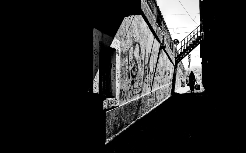 black and white po of a streetlight over a dark alley