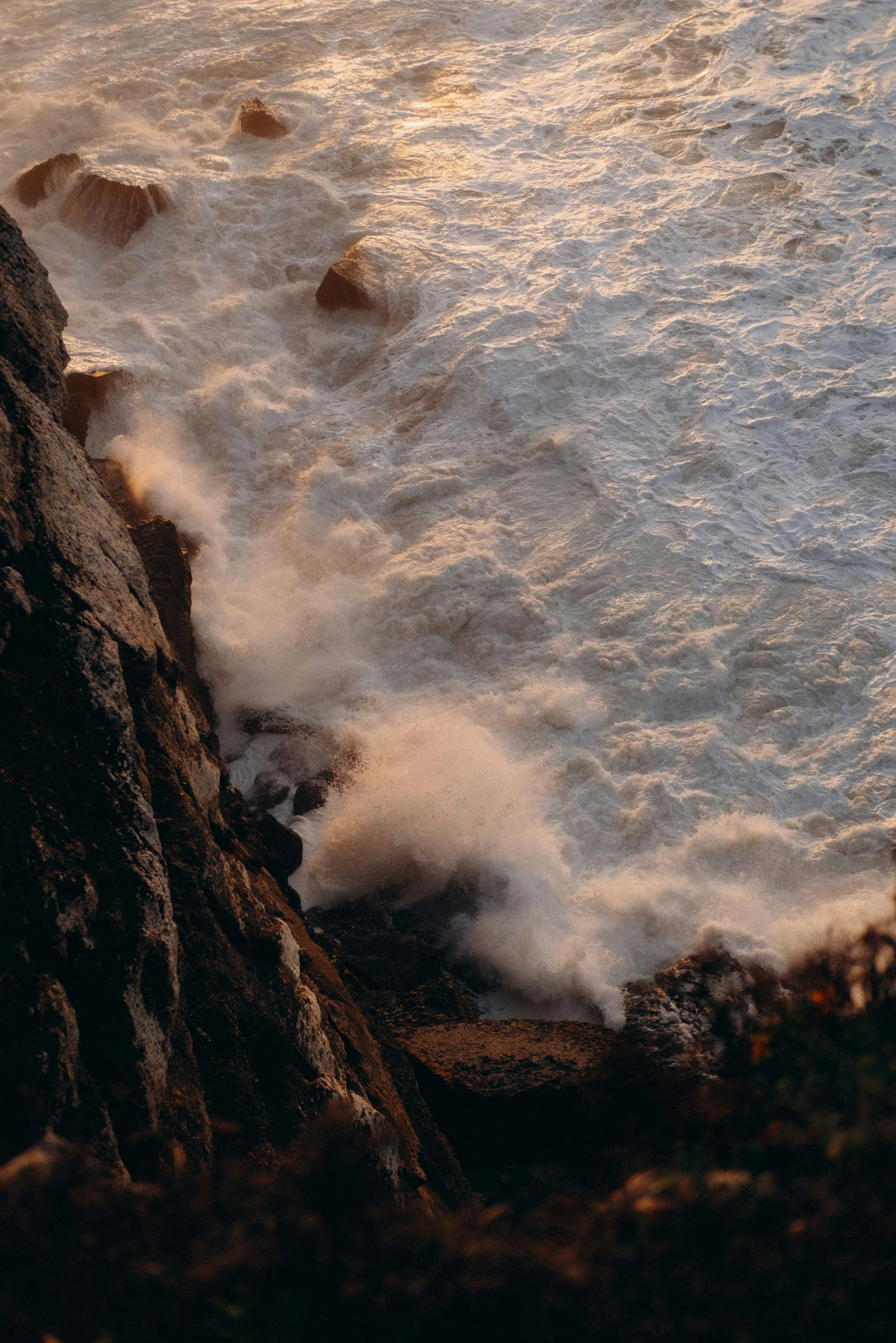 the surf on top of a rocky shore